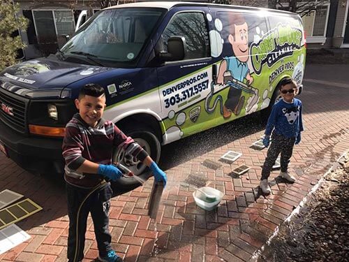 The next generation of Denver Pros helping clean vent covers, a true family business
