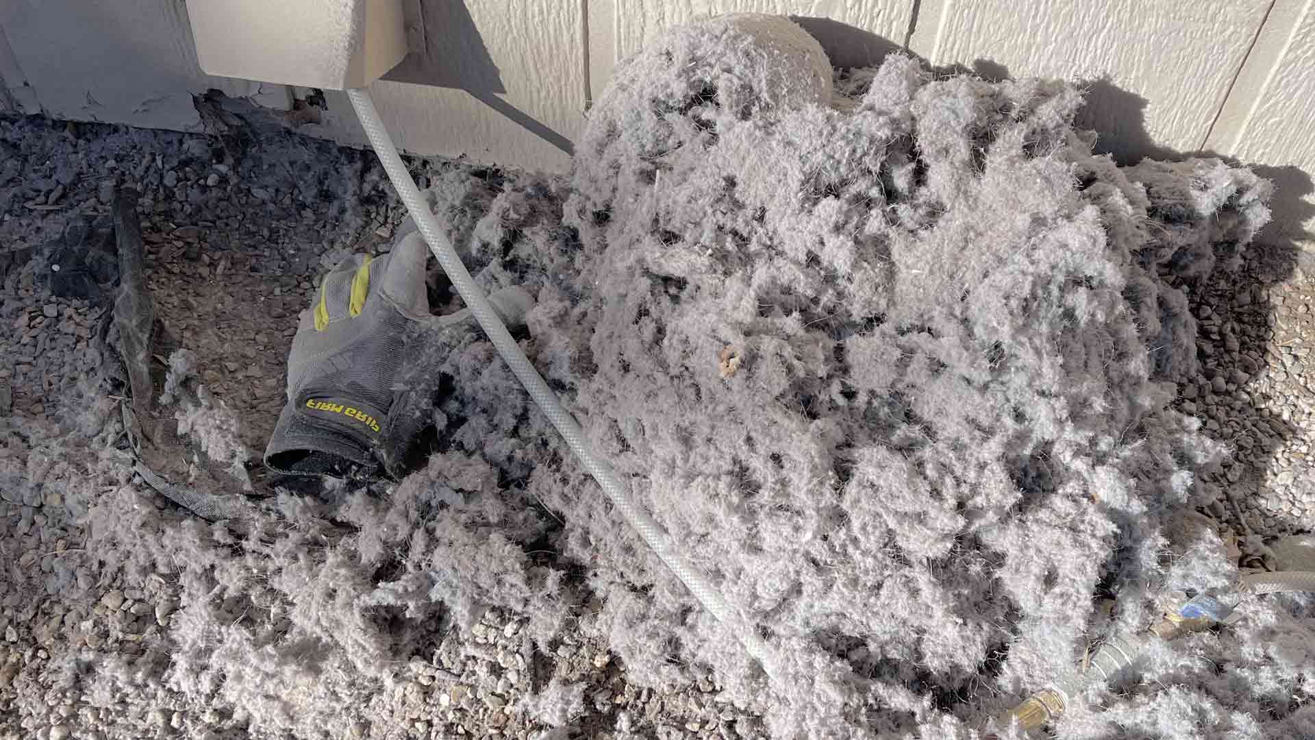 Denver Pros technician cleaning a dryer vent in an Aurora, CO home